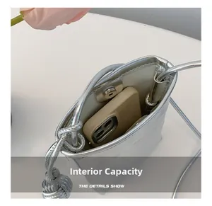 Interior view of silver mini crossbody bag showing magnetic closure and phone storage capacity