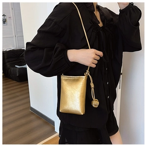 Chic gold metallic textured mini crossbody bag with knotted strap detail and ruched finish