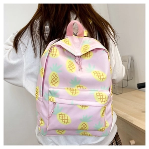 Detailed back view of pink pineapple print backpack showing size on female model