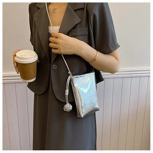 Close-up of metallic silver crossbody phone bag with stylish knotted strap detail