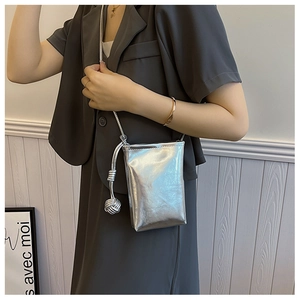 Silver metallic mini crossbody phone bag with knot tassel detail and slim shoulder strap