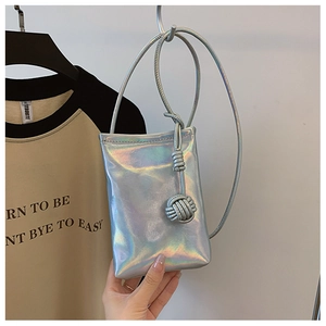 Detailed shot of holographic silver mini crossbody phone bag with knot tassel detail