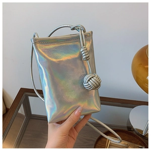 Detail view of a silver holographic mini crossbody bag with braided knot shoulder strap