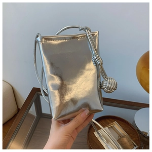 Detail of silver metallic mini crossbody phone bag with handmade woven knot strap