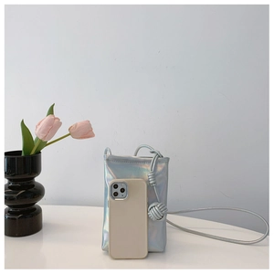 Compact holographic blue phone bag with decorative knot straps and interior storage view