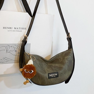 Army green large crescent bag with adjustable strap and cute plush charm detail