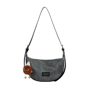 Grey canvas half-moon shoulder bag with adjustable strap and plush charm accent