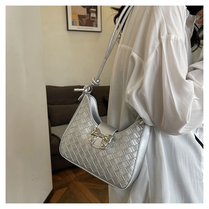 Close-up of a silver woven hobo shoulder bag featuring a stylish bow and knot detail