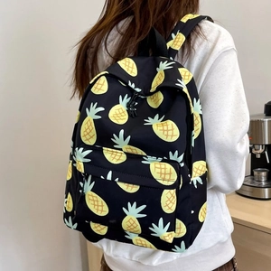 Cute large capacity black backpack featuring yellow pineapple print and zipper pockets