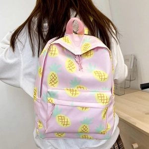 Pink backpack with pineapple print featuring a large main pocket and front zipper pouch