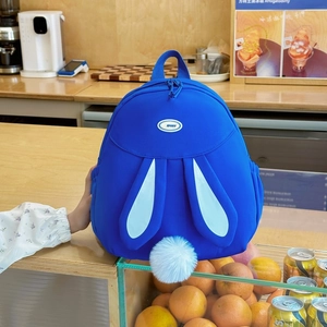 Bright blue rabbit-themed backpack with cute long ears and fluffy pom-pom tail detail