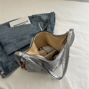 Metallic silver hobo bag with large capacity shown in a stylish lifestyle setting