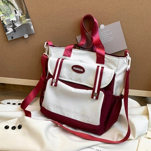 Large capacity color-block shoulder bag with wide strap and fashion pocket detail