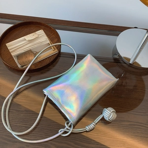 Holographic silver mini crossbody bag with chic knotted shoulder strap and sleek finish