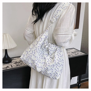 Spacious floral canvas tote bag shown worn over the shoulder for daily style