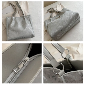 Détails du sac cabas argenté avec boucle métallique et fermeture à glissière lisse