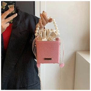 Pink bucket bag with pearl handle, golden chain strap and drawstring closure