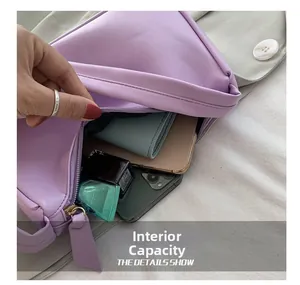 Macro detail of purple underarm bag showing interior capacity for phone and wallet