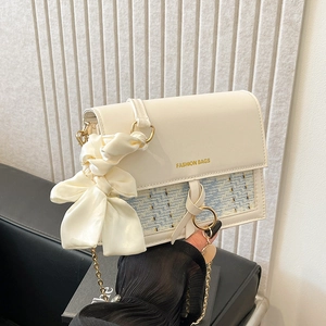 White faux leather shoulder bag with blue tweed panel and large satin bow detail