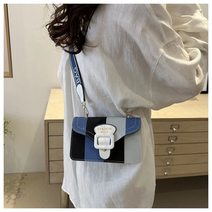 Detail of color-block crossbody bag with wide logo strap and fashion buckle closure