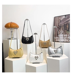 Detailed close-up of multiple baguette bags in yellow, black, white, khaki, and silver
