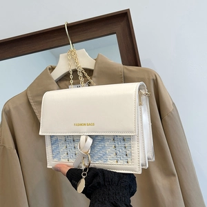 Detail of white PU leather crossbody bag with blue tweed flap and gold chain strap