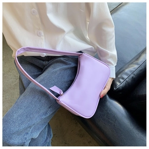 Lavender purple baguette bag in smooth leather finish shown on model's shoulder