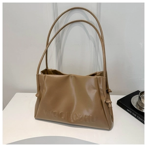 Close-up of khaki faux leather shoulder bag featuring pleated texture and embossed logo