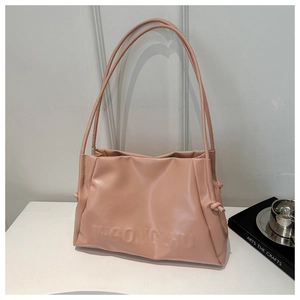 Detail shot of dusty rose tote bag showing soft matte PU leather and embossed brand logo