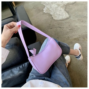 Close-up of a lavender purple faux leather baguette bag with a sleek top zipper detail