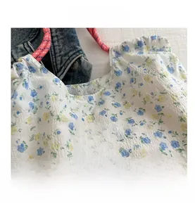 Detail shot of floral canvas tote fabric with fashion instinct label and pink woven strap