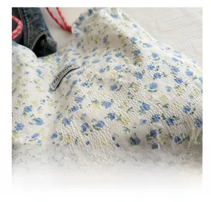 Detail view of floral seersucker fabric and fashion instinct label on canvas tote bag