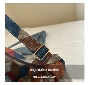 Detail of adjustable golden metal buckle on multi-colored patchwork leather shoulder strap