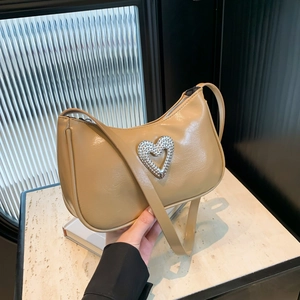 Chic beige baguette bag with a large sparkling rhinestone heart buckle and sleek leather