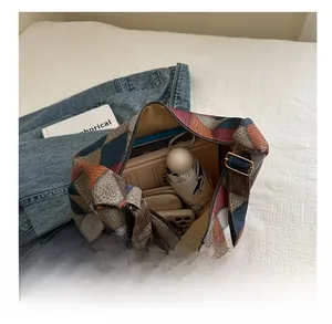 Detail view of a vintage multi-color patchwork tote bag showing large capacity for daily items