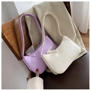 Detailed close-up of minimalist leather underarm bags in light purple and beige tones