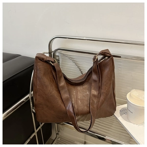 Detail of vintage brown tote bag with adjustable straps and spacious interior