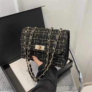 Classic black and gold tweed chain bag with metal twist lock for elegant styling