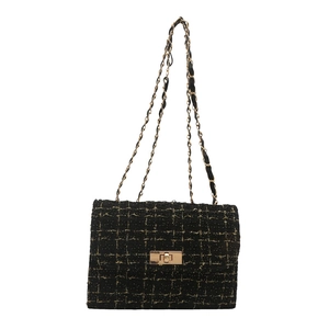 Classic black tweed shoulder bag with golden chain strap and metallic twist lock closure