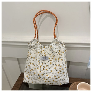 Close-up of floral nylon tote bag featuring drawstring closure and rope handles