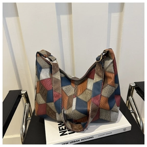 Detail of color-block hobo bag with crocodile and snake skin embossed textures