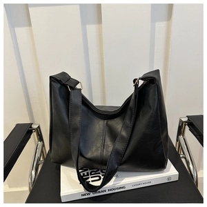 Close-up of black PU leather underarm bag featuring vertical stitching and adjustable strap