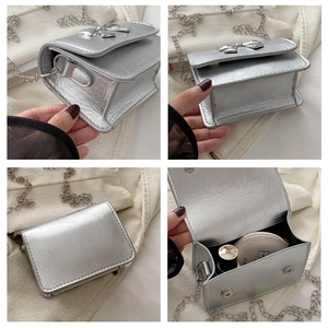 Detail view of silver mini crossbody bag with metal bow and textured leather finish