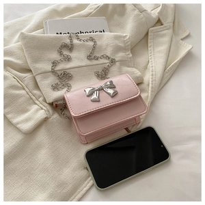 Detail view of pink mini crossbody bag with silver butterfly bow and chain strap
