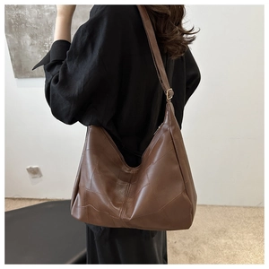 Detail view of large vintage brown patchwork leather tote bag with contrast stitching
