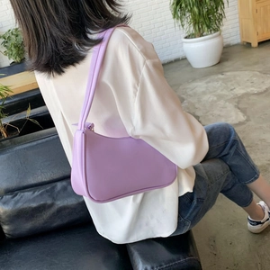 Minimalist lavender faux leather baguette bag for women shown as a stylish shoulder bag