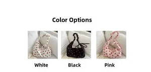 Three crescent canvas bags with strawberry print and pleated straps in white black and pink