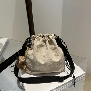 Chic beige nylon drawstring bucket bag with black fashion strap and cute bear charm
