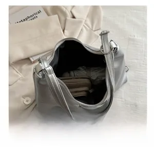 Internal view of silver tote bag showing capacity for umbrella and long wallet