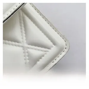 Close-up of white quilted leather texture with premium diamond stitching details